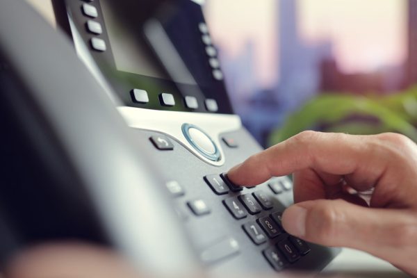 person dialing office phone: how to forward calls on an nec phone