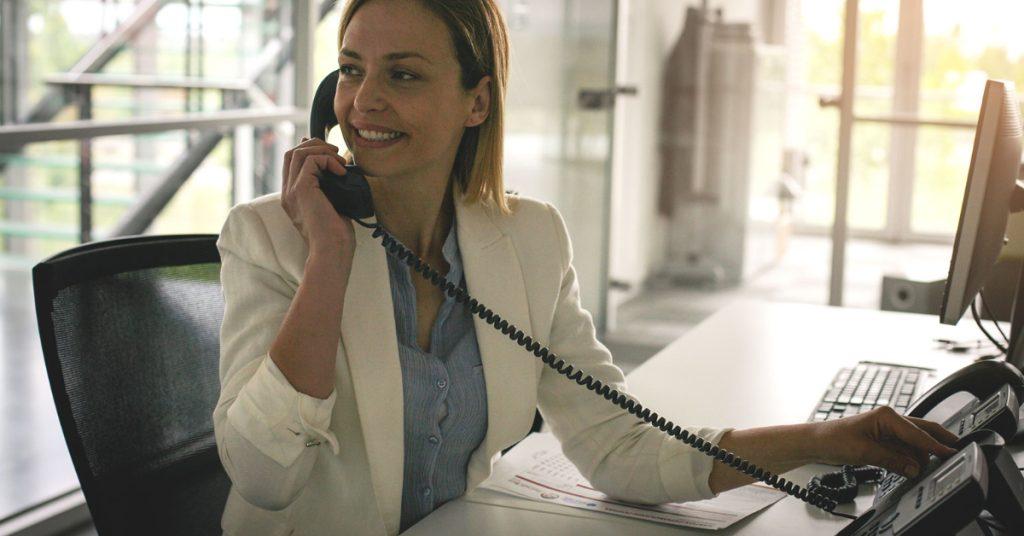Analog vs VoIP Phone System: Keep the Perks, Not the Irks 1 Analog vs VoIP Phone: a woman using her landline business telephone