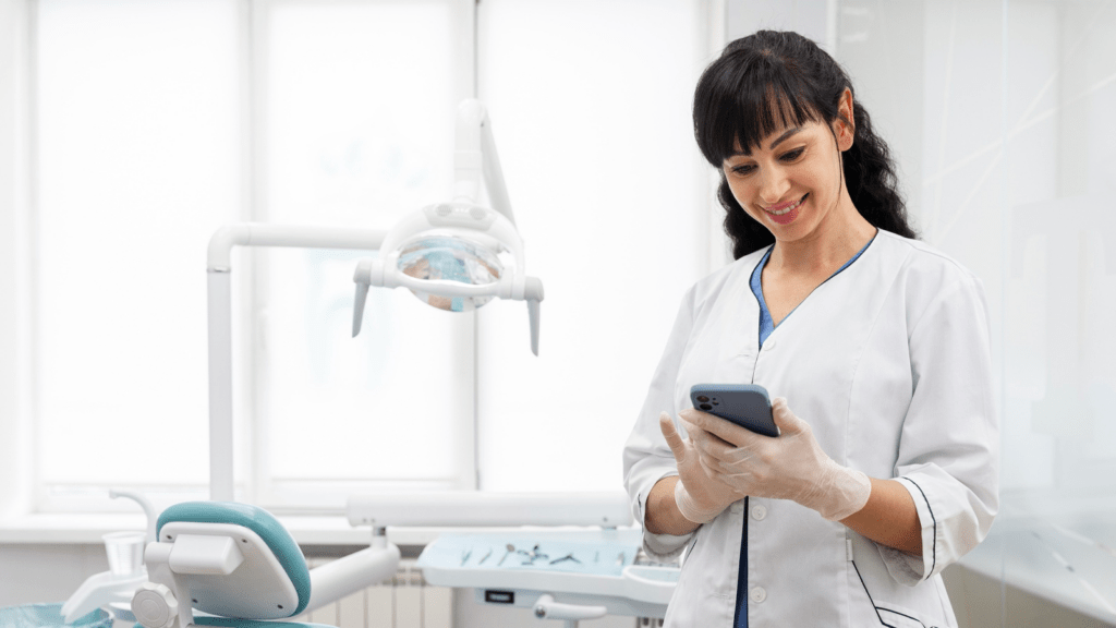 An employee uses a dental office phone system to enhance productivity.