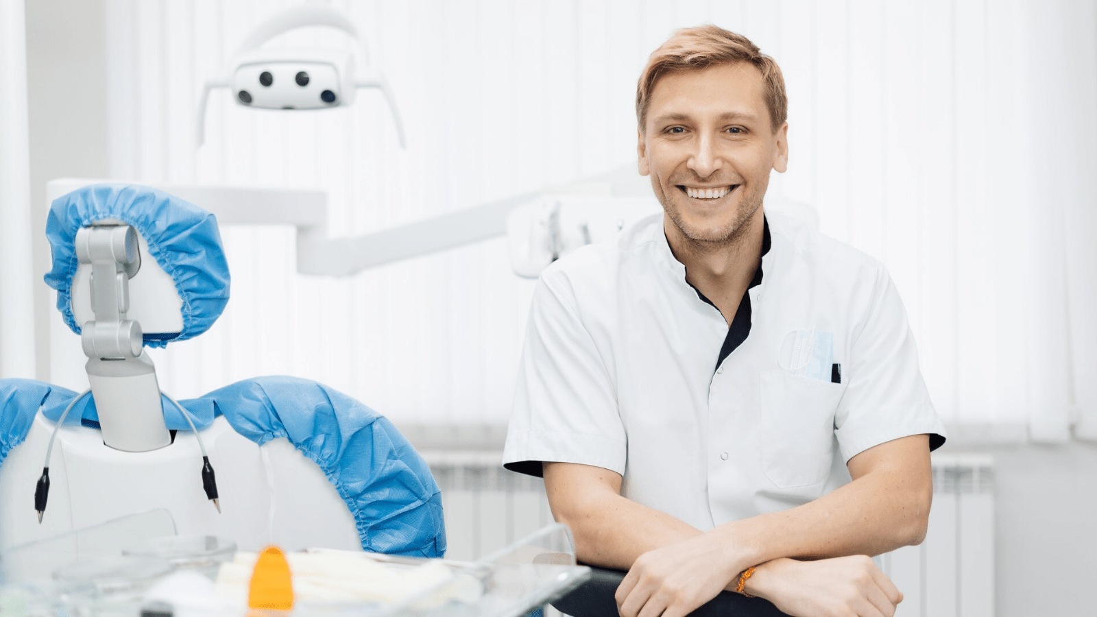 Phone Systems for Dental Offices: Enhancing Patient Communication in New England 3 Male dentist in exam room happy with upgrade to VoIP phone system and the features it's his staff and patients.