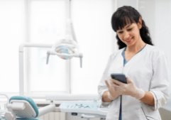 An employee uses a dental office phone system to enhance productivity.