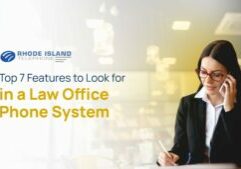 A lawyer sitting at her desk reviewing the list of features the "law practice" need in a "law office phone system."