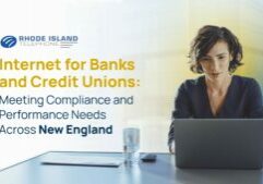 A woman sits at a laptop with a slightly blue and slightly yellow-hued transparent background. On the left of the image we see the Rhode Island Telephone logo along with the title of the blog: 'Internet for Banks and Credit Unions: Meeting Compliance and Performance Needs Across New England'